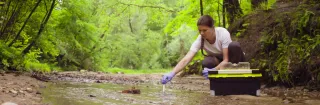 Woman takes water sample