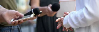Woman gesticulating during interview with media, press conference, close-up