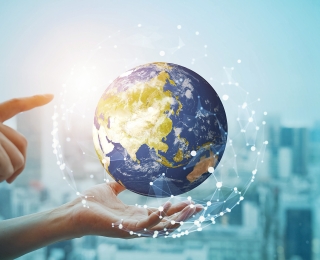 Hand zeigt auf den Planeten Erde