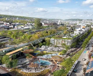 Das Bild zeigt ein Foto des Stadtteils Wuppertal-Oberbarmen. Das Foto wurde digital bearbeitet, um die Potenziale einer sozial-ökologischen Transformation im urbanen Raum zu zeigen. Es lassen sich u.a. vielfältige Begegnungsorte, begrünte Fassaden, klimaneutrale Verkehrsmittel und urbane Gärten erkennen